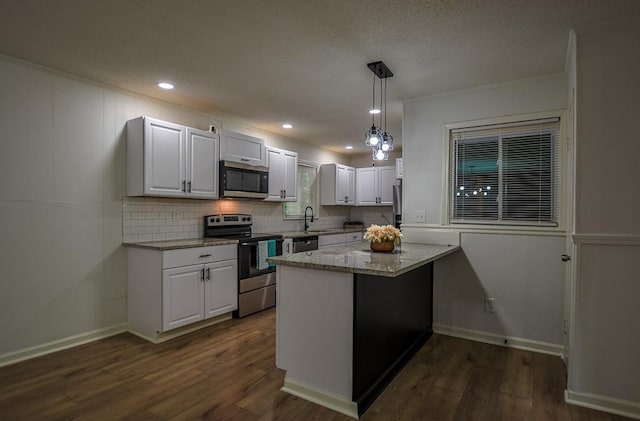 5640 Redan Cir, Stone Mountain, GA 30088 - kitchen featuring appliances with stainless steel finishes, backsplash, white cabinets, light stone countertops, and dark wood-style floors