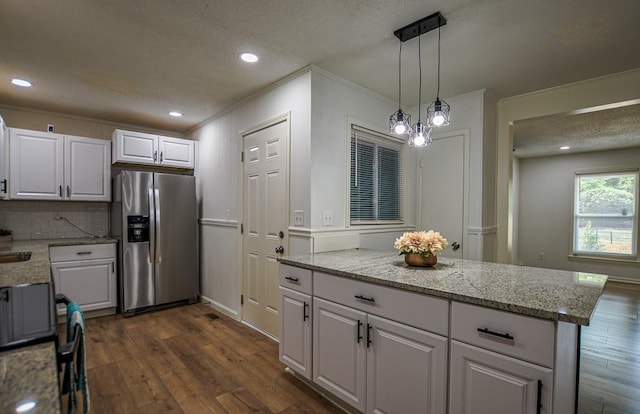 5640 Redan Cir, Stone Mountain, GA 30088 - kitchen featuring stainless steel refrigerator with ice dispenser, white cabinetry, dark wood-style flooring, decorative backsplash, and ornamental molding