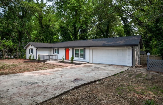 5640 Redan Cir, Stone Mountain, GA 30088 - ranch-style home featuring an attached garage, driveway, brick siding, and a porch