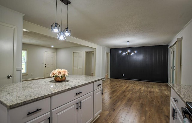 5640 Redan Cir, Stone Mountain, GA 30088 - kitchen featuring dark wood-type flooring, white cabinetry, a textured ceiling, a chandelier, and light stone countertops