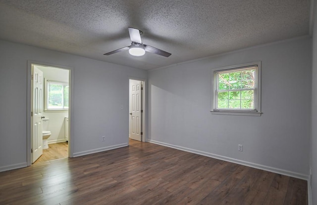 5640 Redan Cir, Stone Mountain, GA 30088 - unfurnished bedroom featuring a textured ceiling, dark wood-type flooring, baseboards, and ensuite bath