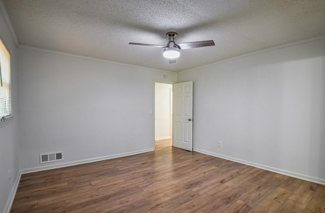 5640 Redan Cir, Stone Mountain, GA 30088 - spare room featuring wood finished floors, a ceiling fan, ornamental molding, a textured ceiling, and baseboards