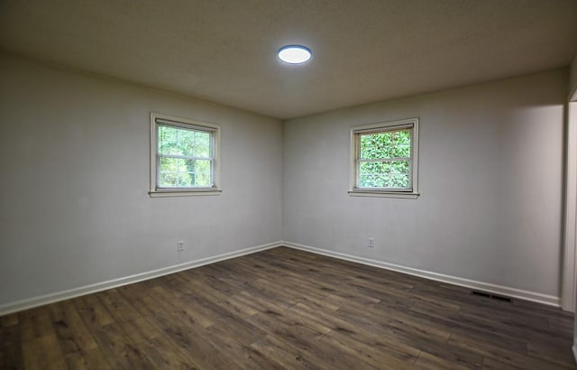 5640 Redan Cir, Stone Mountain, GA 30088 - unfurnished room featuring plenty of natural light, baseboards, and dark wood finished floors
