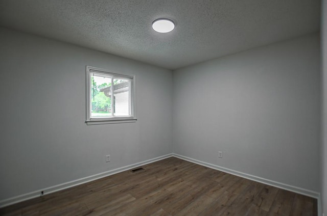 5640 Redan Cir, Stone Mountain, GA 30088 - unfurnished room featuring a textured ceiling, dark wood-style flooring, and baseboards