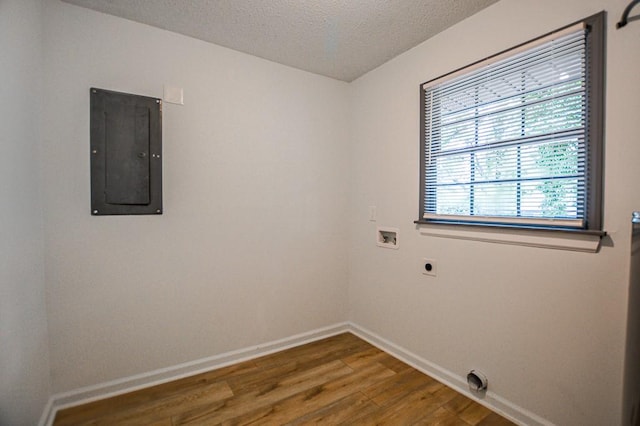 5640 Redan Cir, Stone Mountain, GA 30088 - laundry room with electric panel, hookup for an electric dryer, wood finished floors, hookup for a washing machine, and baseboards