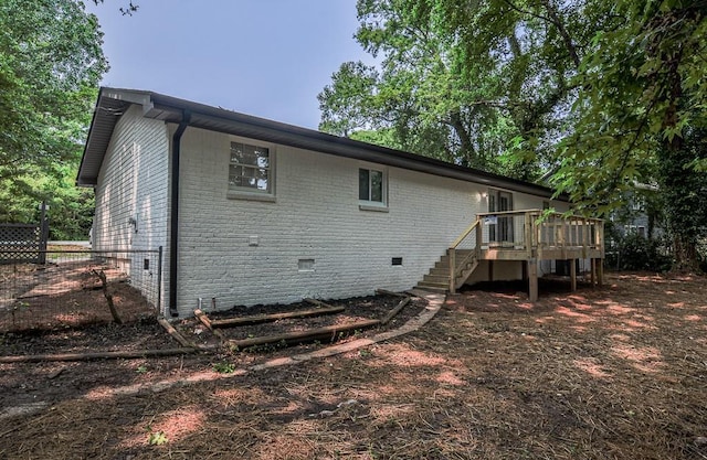 5640 Redan Cir, Stone Mountain, GA 30088 - rear view of house with crawl space, stairway, brick siding, and a wooden deck