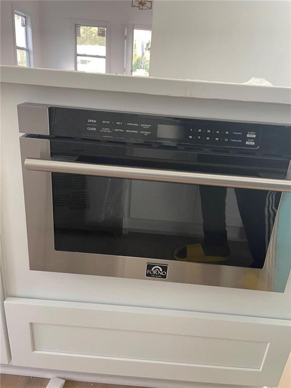 room details featuring oven and white cabinetry