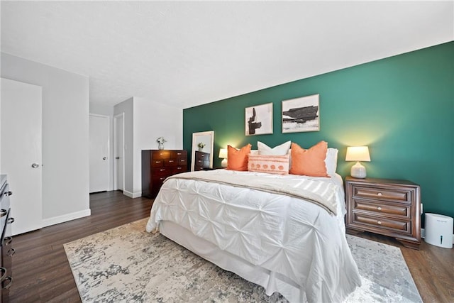 bedroom with dark hardwood / wood-style flooring