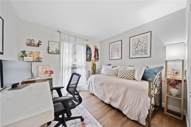 bedroom with dark hardwood / wood-style flooring