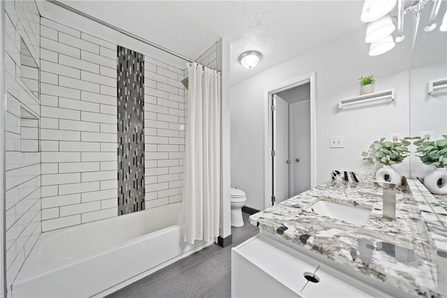 full bathroom with vanity, shower / bath combination with curtain, toilet, and a textured ceiling