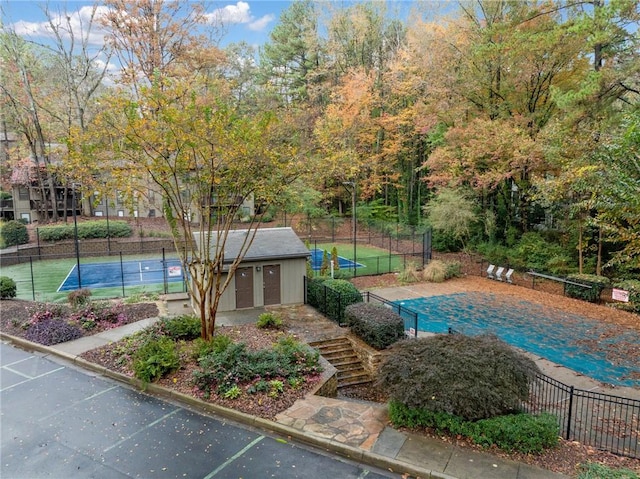 view of swimming pool featuring tennis court