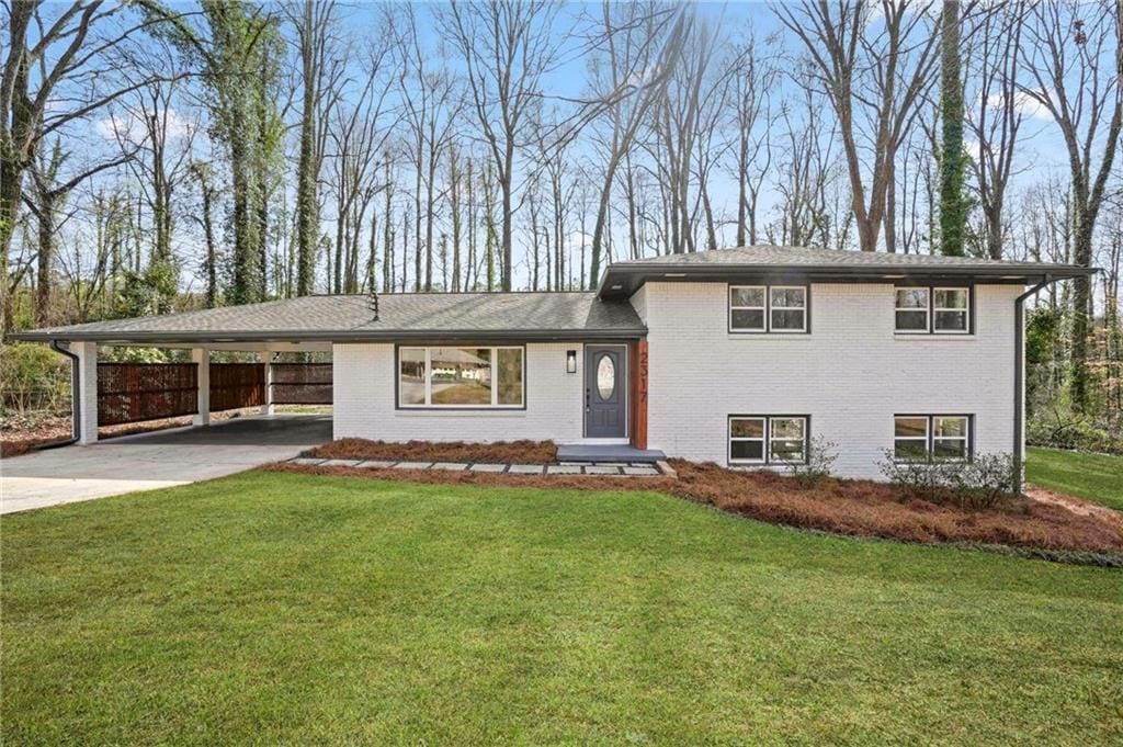 split level home featuring a carport and a front yard