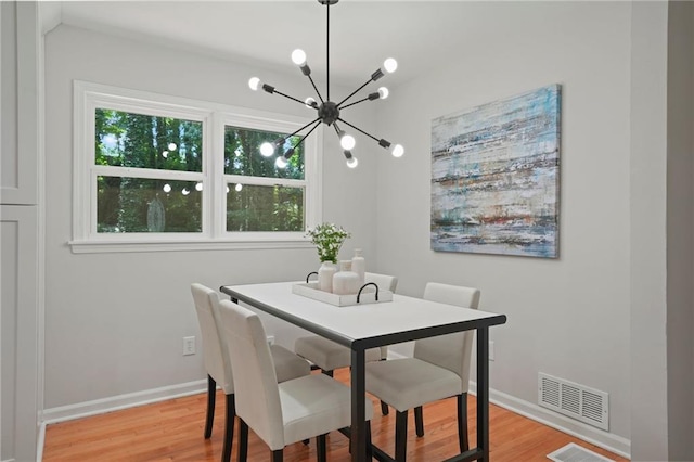 dining room featuring light hardwood / wood-style flooring and a chandelier