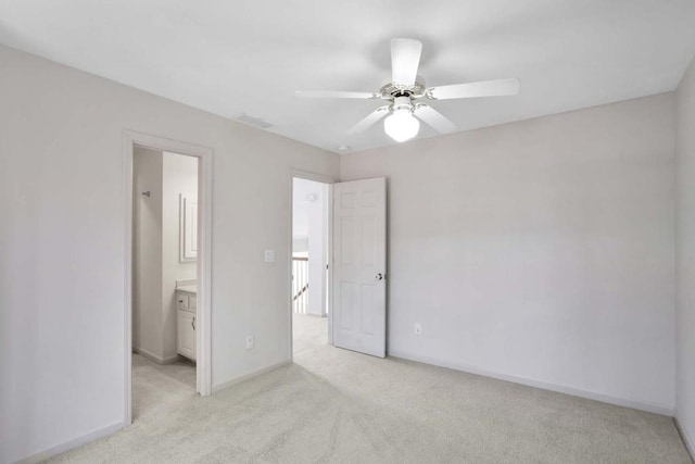 unfurnished bedroom featuring ceiling fan, connected bathroom, and light colored carpet