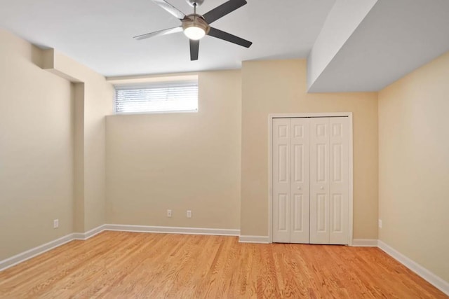 unfurnished bedroom featuring light wood-type flooring, ceiling fan, and a closet