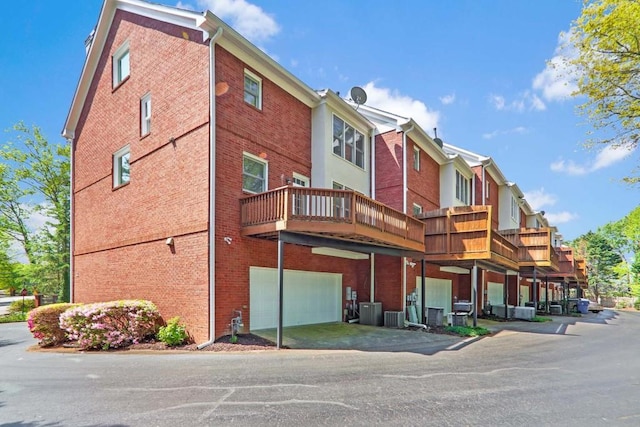 view of property with a garage and central air condition unit