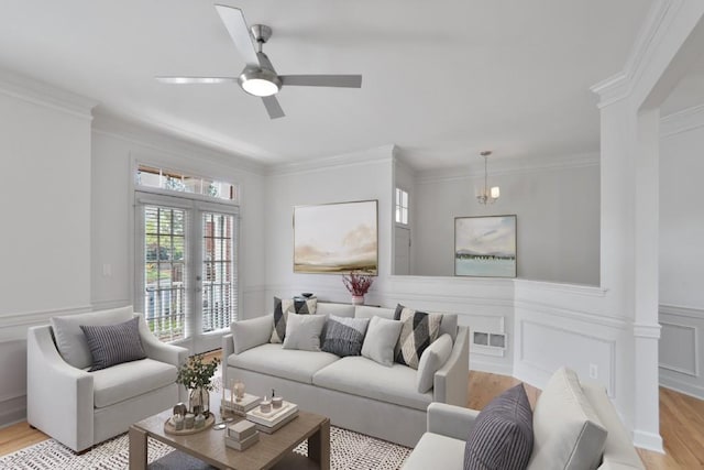 living room featuring crown molding, ceiling fan, and light hardwood / wood-style flooring