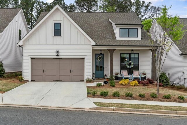 228 Idylwilde Way, Canton, GA 30115 - modern inspired farmhouse featuring board and batten siding, covered porch, roof with shingles, an attached garage, and concrete driveway