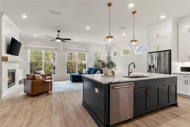 228 Idylwilde Way, Canton, GA 30115 - kitchen featuring white cabinets, open floor plan, a sink, and appliances with stainless steel finishes