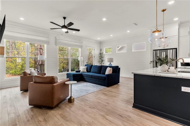 228 Idylwilde Way, Canton, GA 30115 - living area with light wood-style floors, ornamental molding, a ceiling fan, and visible vents