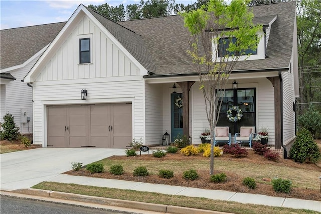 228 Idylwilde Way, Canton, GA 30115 - view of front of house with concrete driveway, roof with shingles, board and batten siding, and covered porch