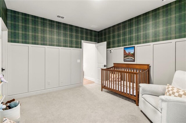 228 Idylwilde Way, Canton, GA 30115 - carpeted bedroom with a nursery area, visible vents, a wainscoted wall, and wallpapered walls
