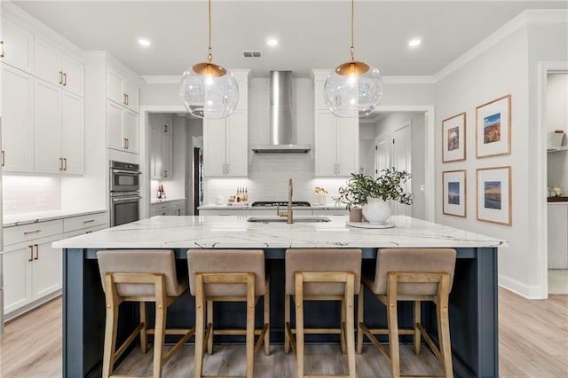 228 Idylwilde Way, Canton, GA 30115 - kitchen featuring wall chimney exhaust hood, double oven, ornamental molding, white cabinets, and visible vents