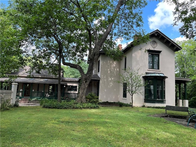 back of property featuring a yard