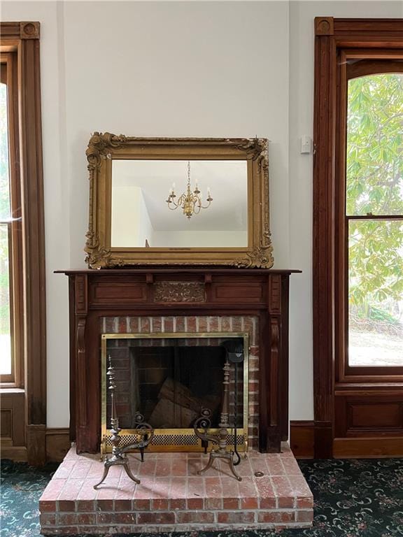 room details featuring a chandelier and dark colored carpet