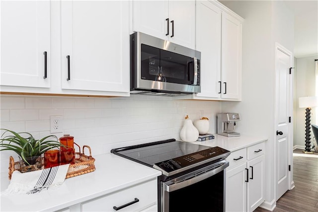 339 Skylar Way SE, Atlanta, GA 30315 - kitchen with electric range oven, stainless steel microwave, light countertops, white cabinetry, and tasteful backsplash