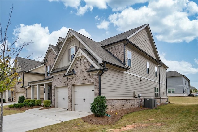 view of home's exterior with a garage, cooling unit, and a lawn