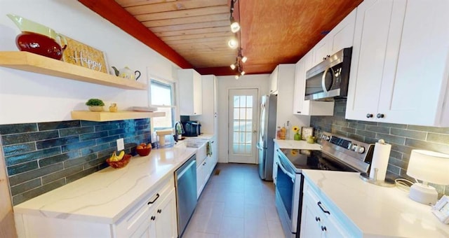 kitchen featuring wooden ceiling, white cabinetry, appliances with stainless steel finishes, decorative backsplash, and open shelves