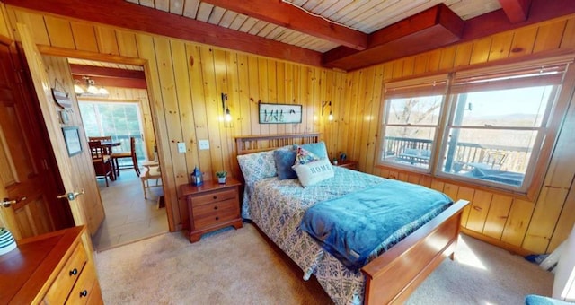 bedroom featuring beam ceiling, light colored carpet, an inviting chandelier, wooden walls, and wooden ceiling