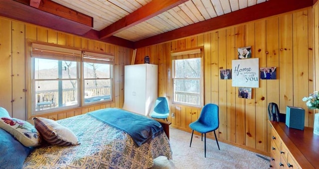 bedroom featuring wood ceiling, light colored carpet, beamed ceiling, and wooden walls