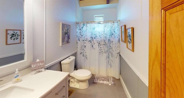 bathroom featuring toilet, curtained shower, tile patterned flooring, and vanity