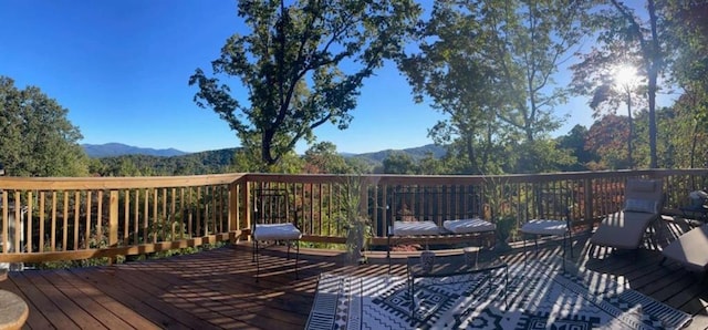 wooden deck featuring a mountain view