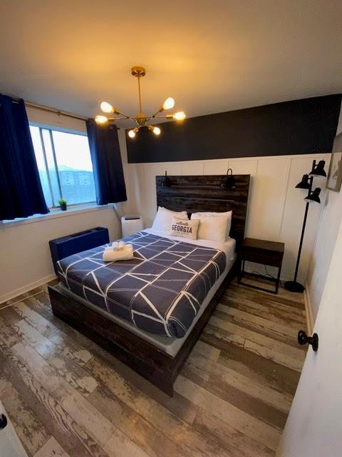 bedroom featuring hardwood / wood-style floors and a notable chandelier