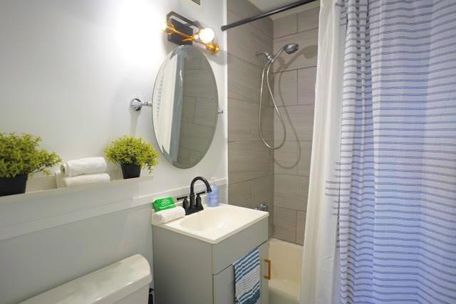 full bathroom with vanity, shower / tub combo, and toilet