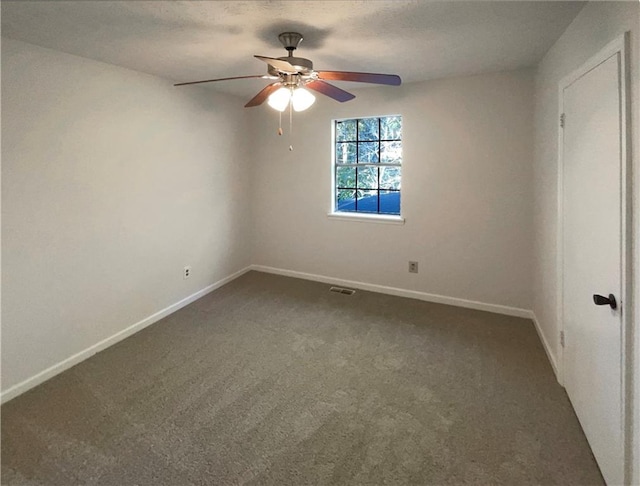 empty room featuring carpet flooring, ceiling fan, and a textured ceiling