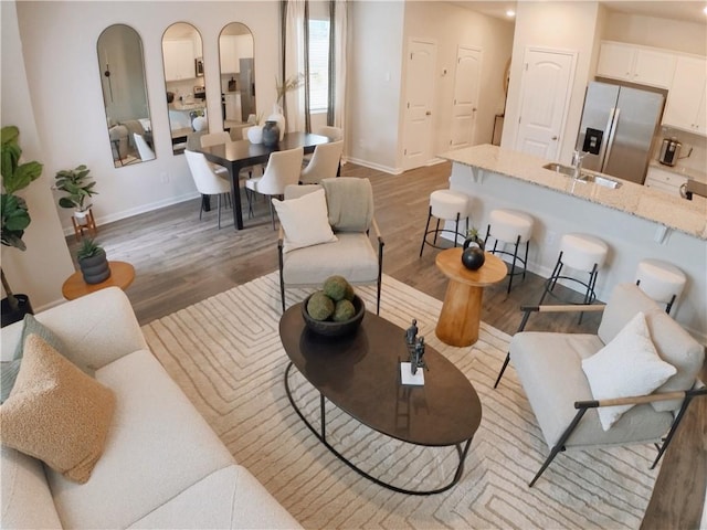 living room with hardwood / wood-style flooring and sink