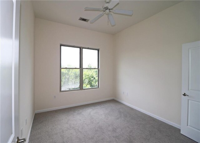 empty room with carpet flooring, baseboards, and ceiling fan
