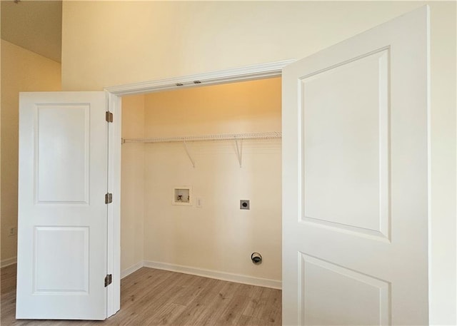 laundry room featuring electric dryer hookup, light wood-style flooring, washer hookup, and baseboards