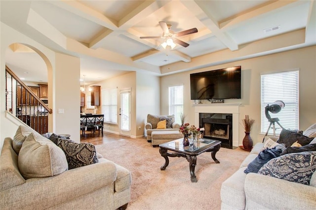3746 Okefenokee Rdg, Loganville, GA 30052 - living room featuring coffered ceiling, a ceiling fan, stairway, baseboards, and a fireplace with flush hearth