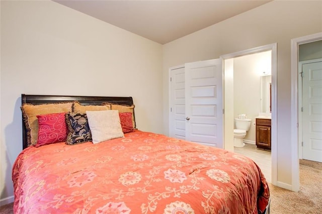 3746 Okefenokee Rdg, Loganville, GA 30052 - bedroom with light carpet, ensuite bath, and baseboards