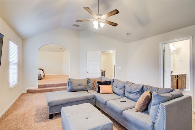 3746 Okefenokee Rdg, Loganville, GA 30052 - living area featuring a ceiling fan, light carpet, arched walkways, lofted ceiling, and plenty of natural light