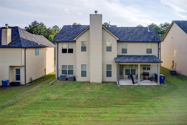 3746 Okefenokee Rdg, Loganville, GA 30052 - back of property featuring a patio area, a chimney, central air condition unit, and a lawn