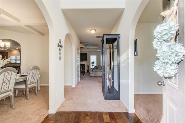 3746 Okefenokee Rdg, Loganville, GA 30052 - entrance foyer with dark colored carpet, dark wood-style flooring, and baseboards