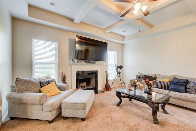 3746 Okefenokee Rdg, Loganville, GA 30052 - living area with coffered ceiling, carpet, ceiling fan, beam ceiling, and a fireplace with flush hearth
