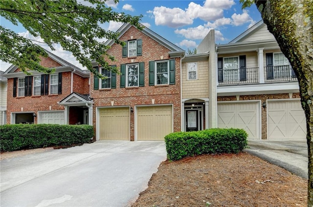 2515 Gadsen Walk, Duluth, GA 30097 - townhome / multi-family property featuring driveway, a garage, brick siding, and a balcony