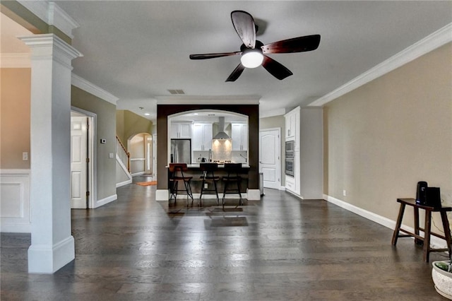 2515 Gadsen Walk, Duluth, GA 30097 - living area with ornamental molding, a ceiling fan, stairway, dark wood finished floors, and arched walkways
